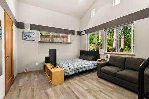 a living room with a couch and a tv at Dash Point Modern in Tacoma