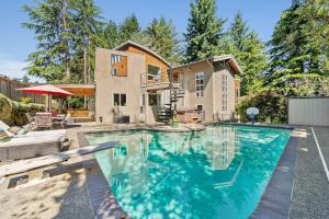 a large swimming pool in front of a house at Dash Point Modern in Tacoma