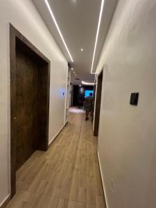 a hallway of an office building with a wooden door at Bgold home Apartment in Lekki
