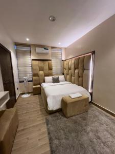 a bedroom with a large bed with a tufted headboard at Bgold home Apartment in Lekki