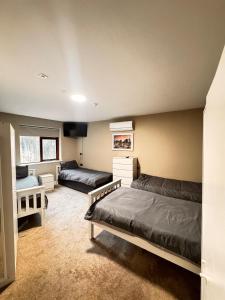 a bedroom with two beds and a tv in it at The Ambassador Apartment in Carrick on Shannon