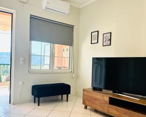 a living room with a large flat screen tv at Casa Panorama in Igoumenitsa