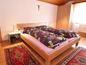 a bedroom with a bed and a cross on the wall at holiday home in M rel near the Aletsch ski area in Mörel