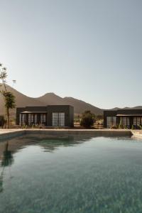 a large pool of water in front of a building at Nangi Hotel Boutique in Valle de Guadalupe