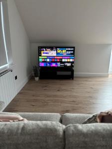 a living room with a couch and a flat screen tv at Skellig Bliss in Valentia Island