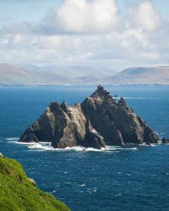 a rocky island in the ocean on a cloudy day at Skellig Bliss in Valentia Island