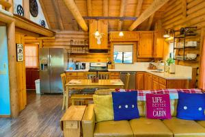 a living room with a couch and a kitchen at Deer Lane Lodge in Idyllwild