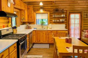 a kitchen with wooden cabinets and a stove top oven at Deer Lane Lodge in Idyllwild
