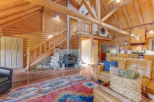 a living room with a fireplace in a log cabin at Deer Lane Lodge in Idyllwild