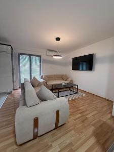a living room with a couch and a table at DrimResidence in Struga