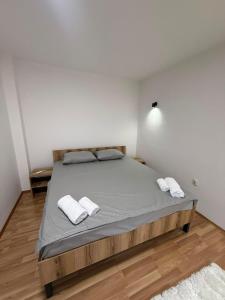 a bedroom with a bed with two white towels on it at DrimResidence in Struga