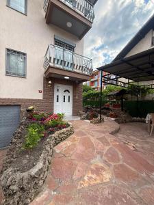a house with a stone walkway in front of a building at DrimResidence in Struga