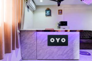 a purple counter with an ovo sign on it at Hotel O Eleven in Jabalpur
