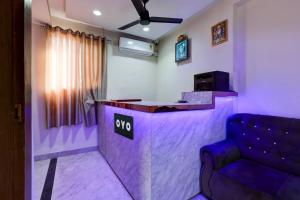 a purple bar with a couch in a room at Hotel O Eleven in Jabalpur