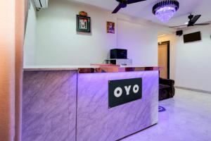 an office with a purple counter with an ovo sign on it at Hotel O Eleven in Jabalpur