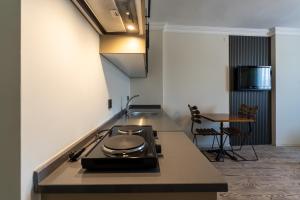 a kitchen with a stove and a counter top at Karacan Hotel - Dalaman Airport in Dalaman