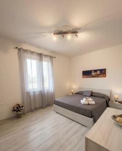 a bedroom with a bed and a large window at Le 4 Rondini in Spello