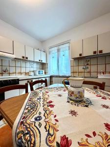 a kitchen with a table with a vase on it at Le 4 Rondini in Spello +14 photos