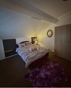 a bedroom with a large bed with a lamp and a rug at Filip in Sarajevo