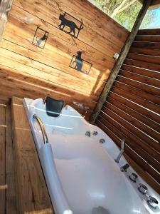 a bathroom with a tub and a dog on the wall at Alpinas del bosque II in Maldonado +6 photos