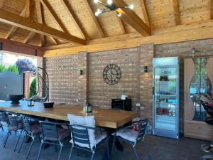 a dining room with a large wooden table and chairs at River House Batrovci in Batrovci