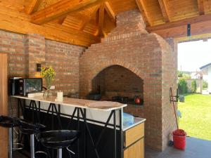an outdoor kitchen with a brick oven at River House Batrovci in Batrovci