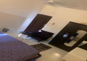 a living room with a chair and a mirror at Brise de Mer Azur in Djibouti