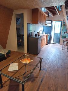 a kitchen with a glass table in the middle of a room at Alpinas del bosque II in Maldonado