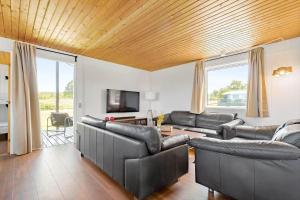 a living room with leather furniture and a flat screen tv at 8599-Glesborg-Amagervej-4 in Glesborg