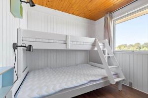 a bunk bed in a room with a window at 8599-Glesborg-Amagervej-4 in Glesborg