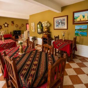 a dining room with two tables with red table cloth at El Crestón Hotel in Coronel Moldes