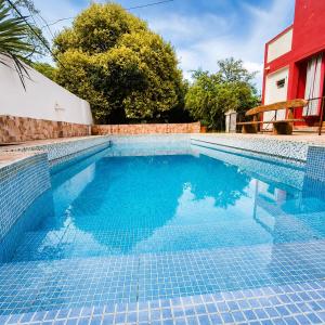 a swimming pool with blue water in a house at El Crestón Hotel in Coronel Moldes