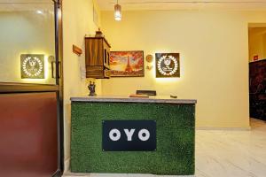 a green counter with an ovy sign on it at Hotel O City View in Alīgarh