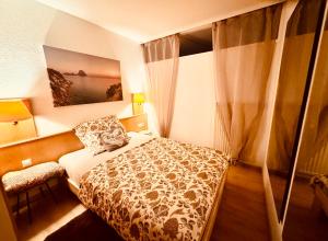 a small bedroom with a bed and a window at FeWo Fuchs Saig in Lenzkirch
