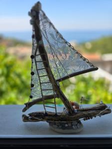 a small model of a boat sitting on a table at Apartman Alba in Petrovac na Moru +4 photos