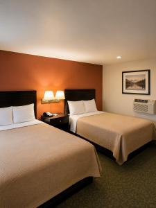 a hotel room with two beds and two lamps at DEEPWELL MOTEL in Owego