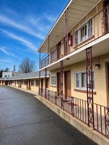 a building with balconies on the side of it at DEEPWELL MOTEL in Owego
