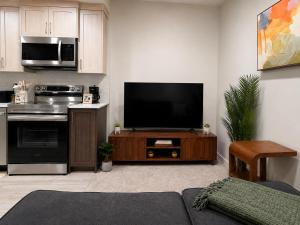 a living room with a flat screen tv at Cozy Private 1BR Basement Suite in Calgary