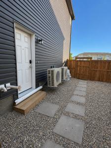 a door to a house with a fan next to it at Cozy Private 1BR Basement Suite in Calgary