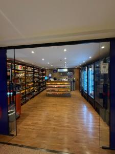 a aisle in a store with glass doors and wooden floors at Flat Hotel S4 - Aguas Claras in Brasília