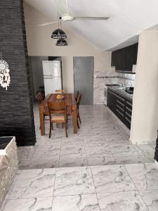 a kitchen with a table and chairs and a refrigerator at Aurea san antonio in San Antonio de Arredondo +5 photos