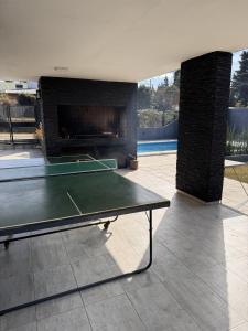 a ping pong table in a patio with a fireplace at Aurea san antonio in San Antonio de Arredondo