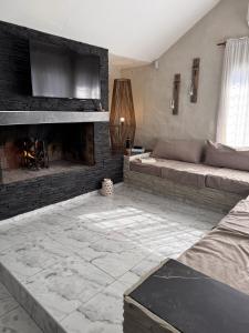 a living room with a couch and a fireplace at Aurea san antonio in San Antonio de Arredondo