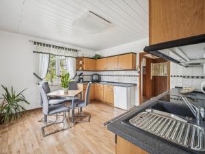 a kitchen and dining room with a table and chairs at Frida in Lichtenhain