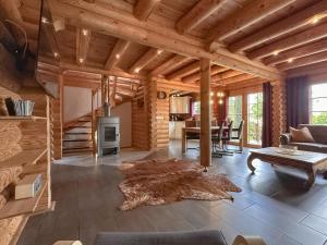 a living room with a wooden ceiling and a table at Bavaria in Teunz