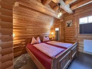 a bedroom with a bed in a log cabin at Bavaria in Teunz