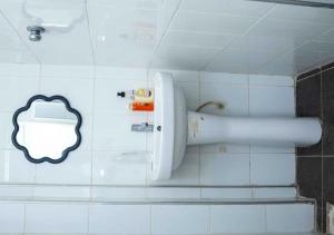 a bathroom with a mouth painted on the wall at Mycom Apartment in Kumasi