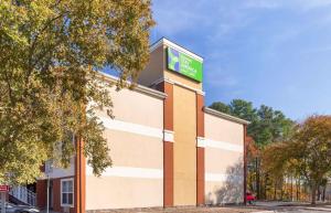 a building with a sign on the side of it at Extended Stay America Select Suites - Raleigh - RDU Airport in Morrisville