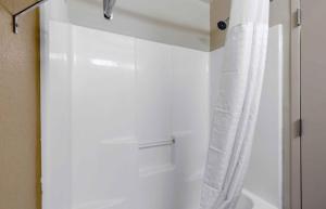 a bathroom with a shower with a white shower curtain at Extended Stay America Select Suites - Raleigh - RDU Airport in Morrisville +22 photos