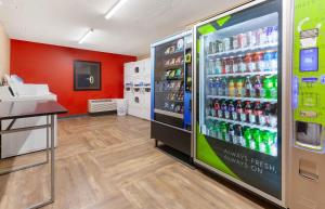 a store with a refrigerator filled with lots of soda bottles at Extended Stay America Select Suites - Appleton - Fox Cities in Appleton